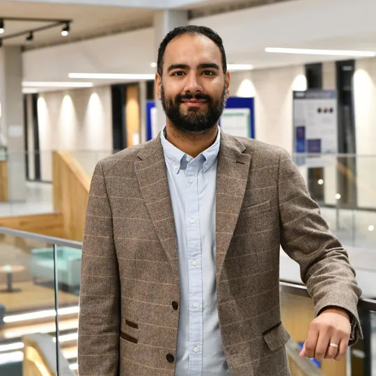 Photo of a male lecturer stood in Moss house.