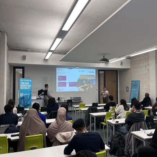 classroom of students listening to a guest speaking sessions.
