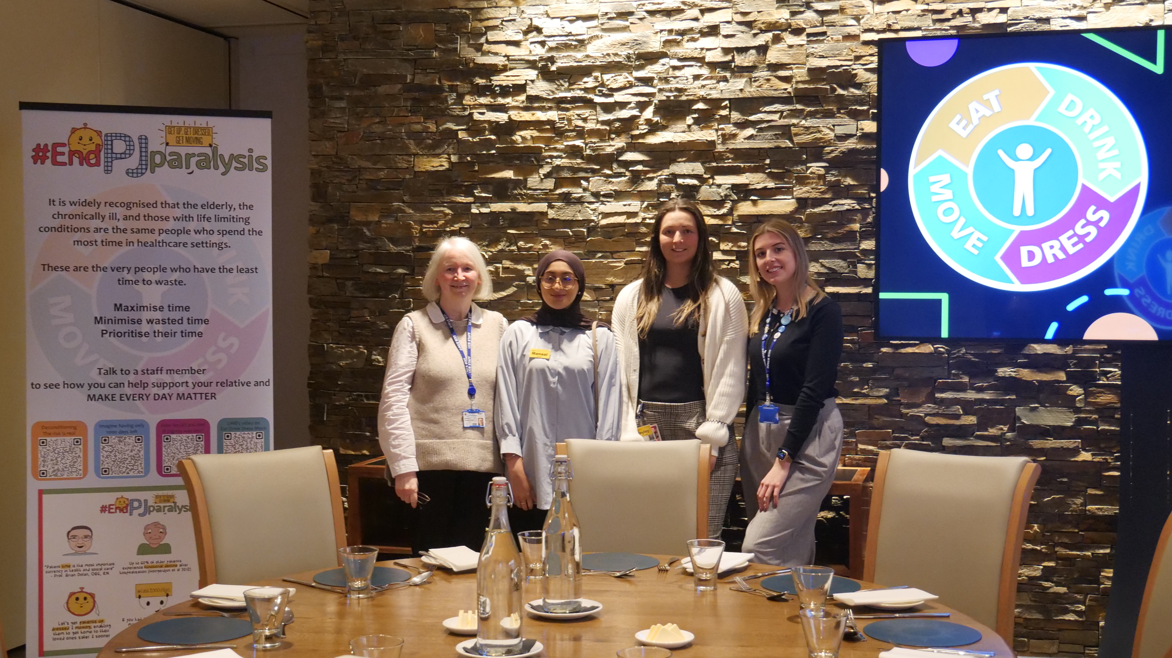 Two University College Birmingham lecturers gather round two guest speakers at a dietetics global tea party event