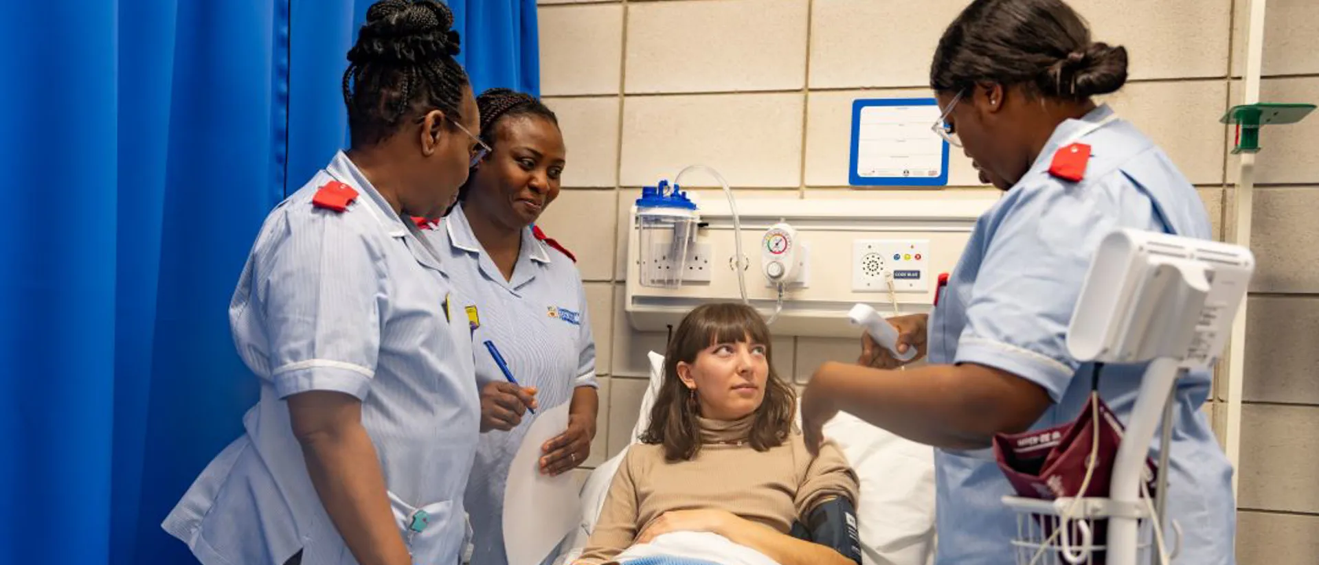 Patient being assessed by nursing students in a medical room