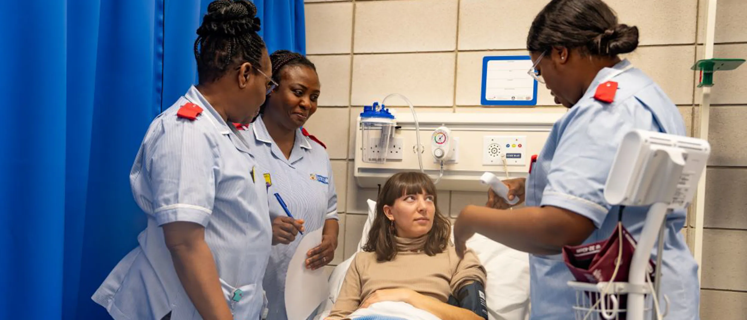 Patient being assessed by nursing students in a medical room
