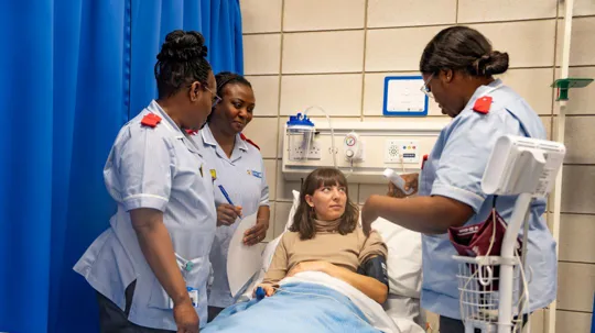 Patient being assessed by nursing students in a medical room