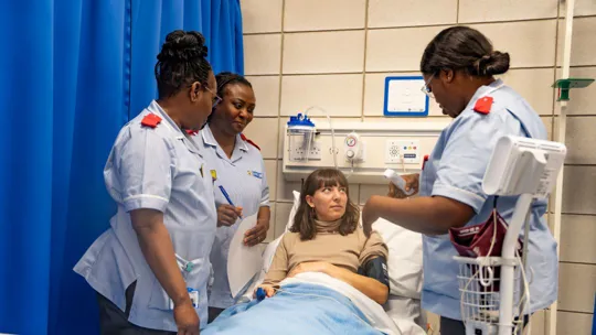 Patient being assessed by nursing students in a medical room