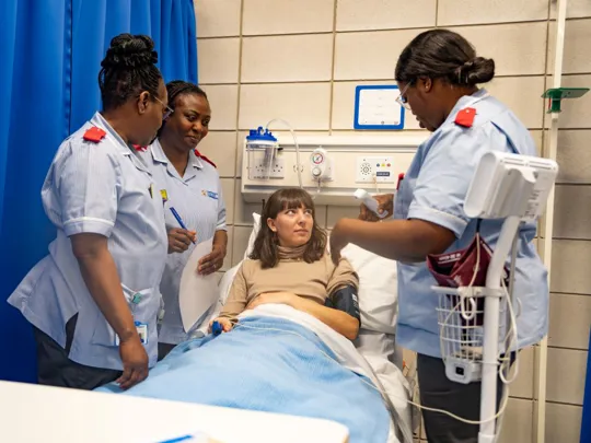 Patient being assessed by nursing students in a medical room