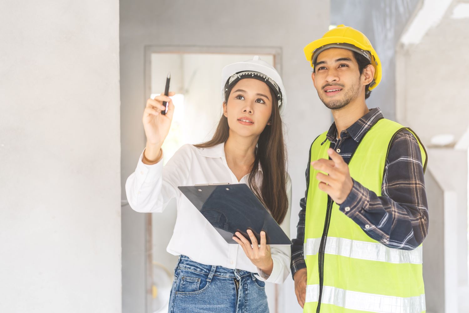 Two construction students evaluating a project.