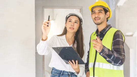 Two construction students evaluating a project.