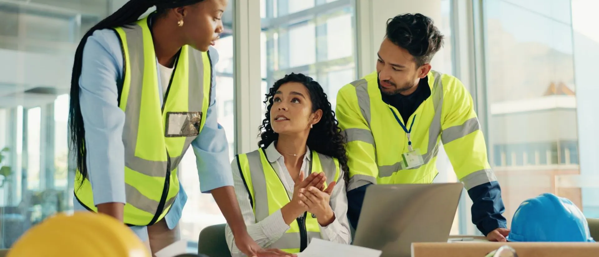 Group of construction student collaborating over a laptop