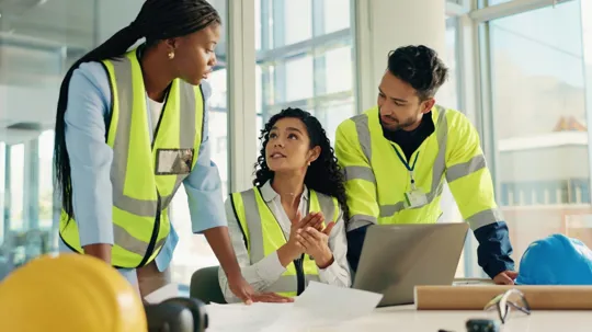 Group of construction student collaborating over a laptop