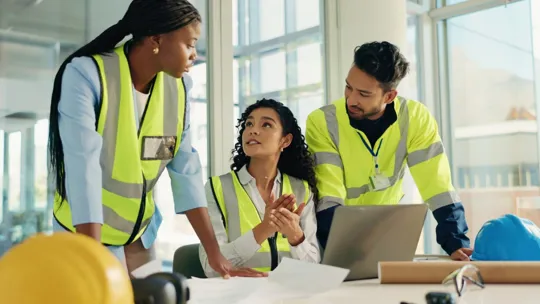 Group of construction student collaborating over a laptop
