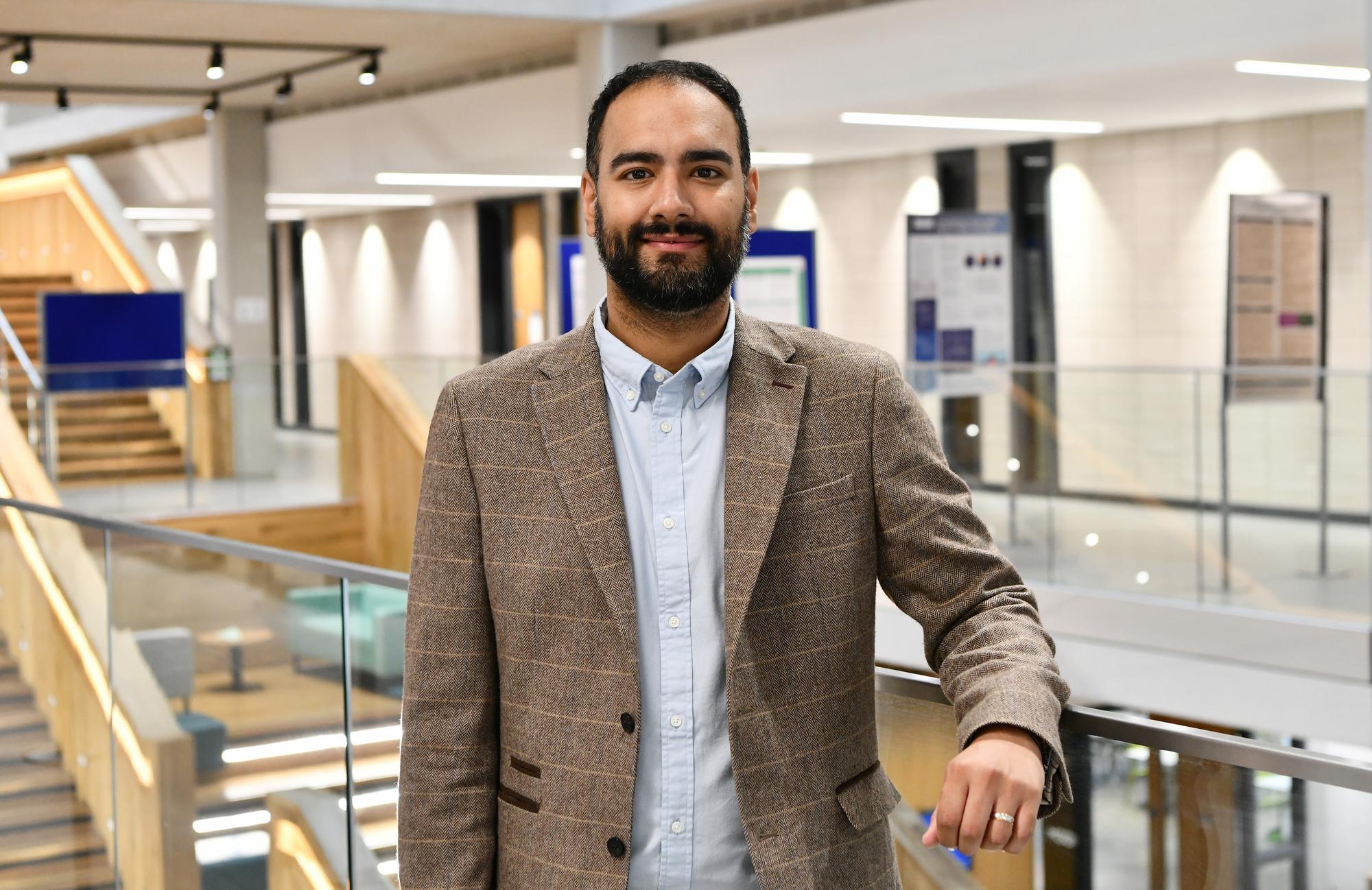 Photo of a male lecturer stood in Moss house.