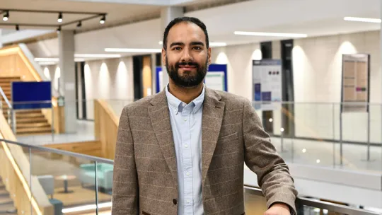 Photo of a male lecturer stood in Moss house.
