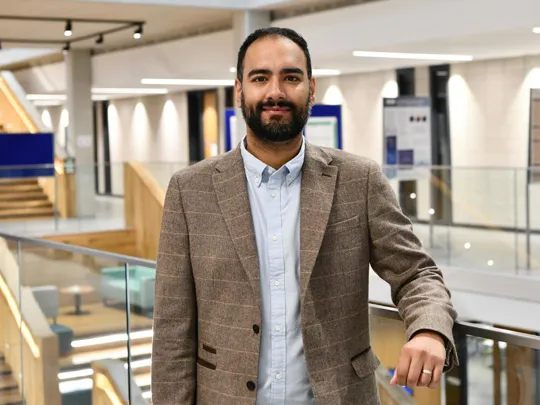 Photo of a male lecturer stood in Moss house.
