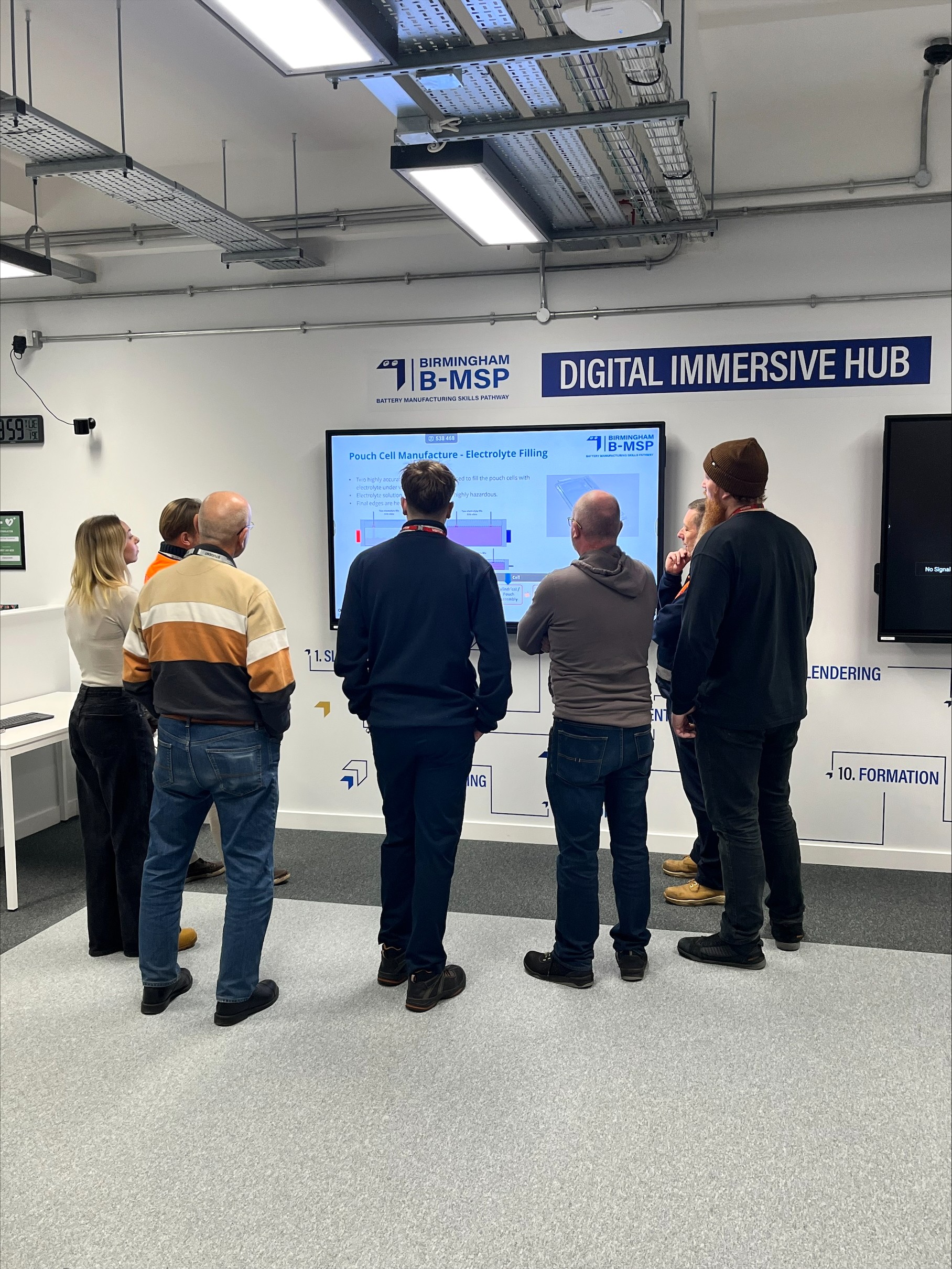 Students stood around an immersive screen.