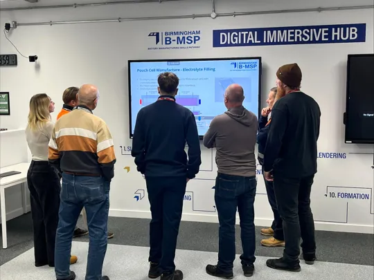 Students stood around an immersive screen.