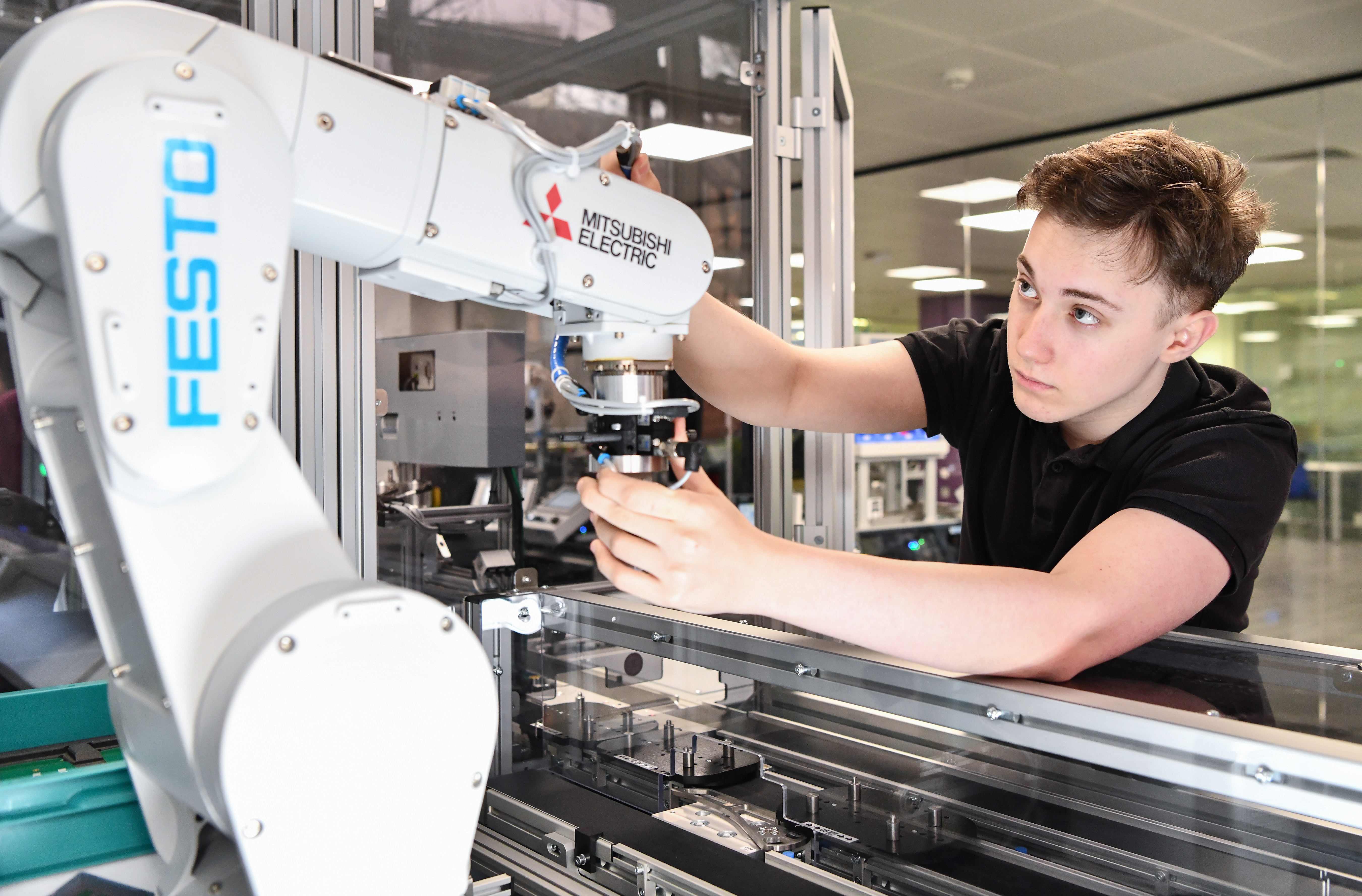 Student working with a robotic arm.