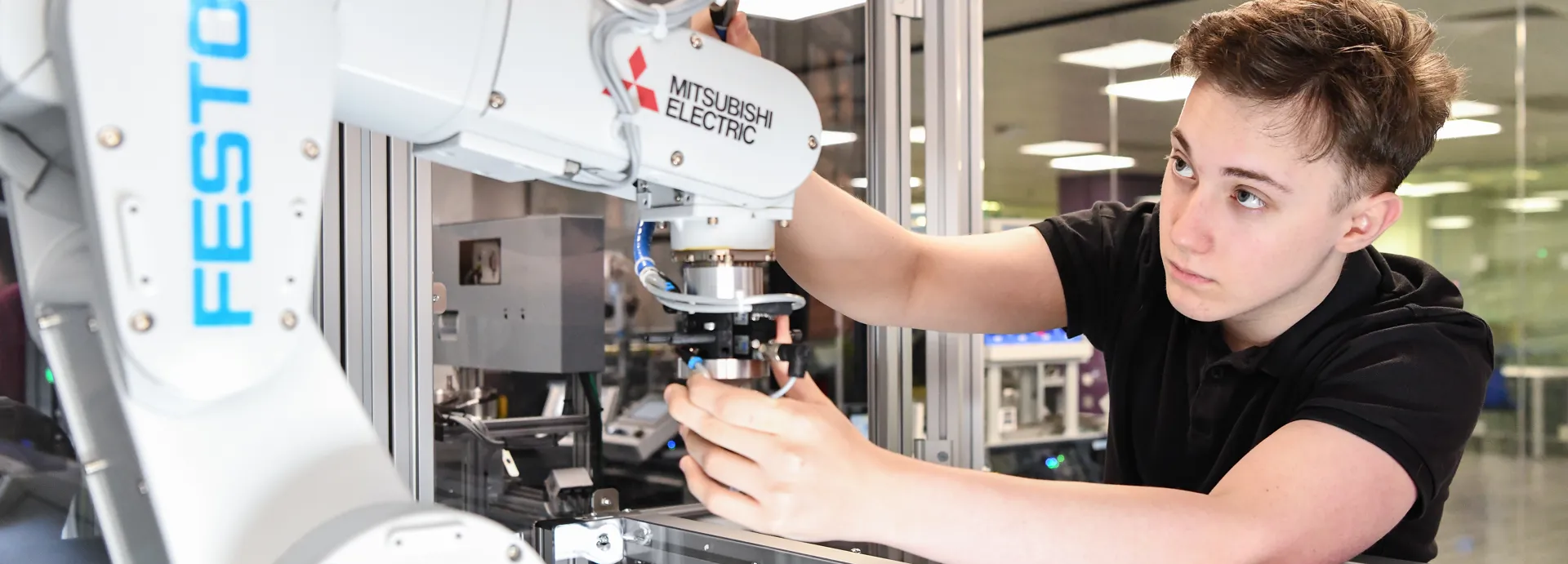 Student working with a robotic arm.