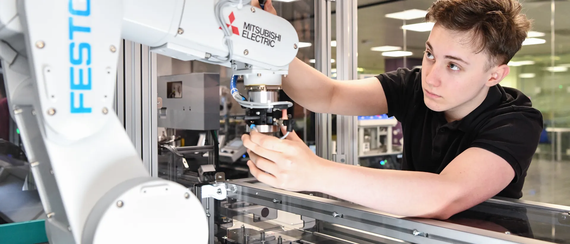 Student working with a robotic arm.
