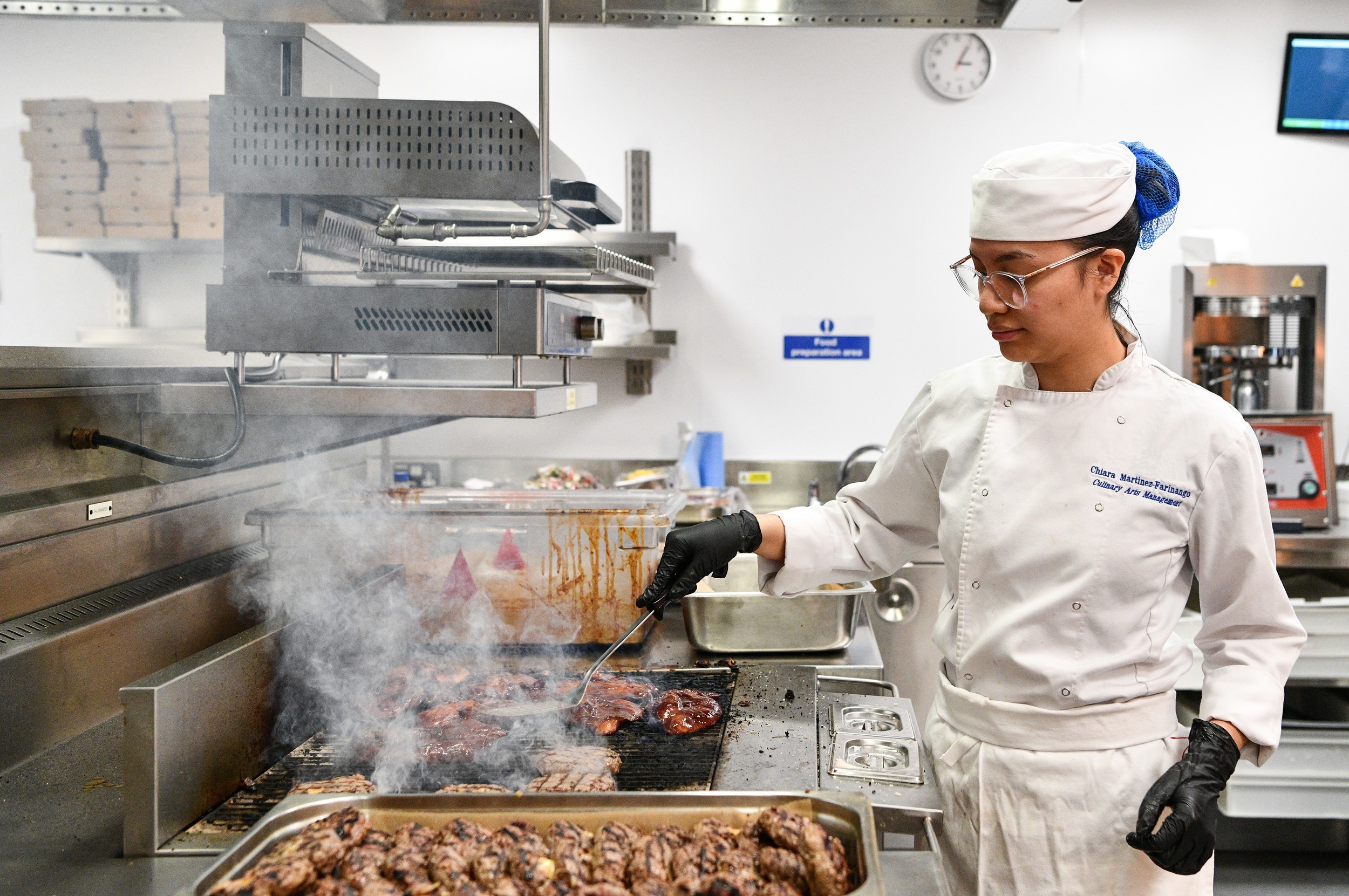 Commis chef cooking in kitchen