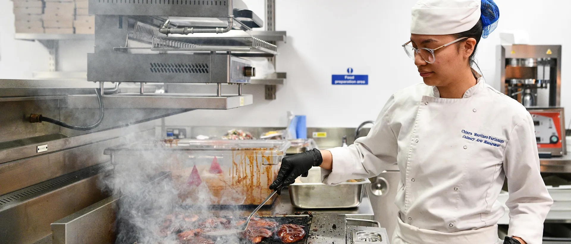 Commis chef cooking in kitchen