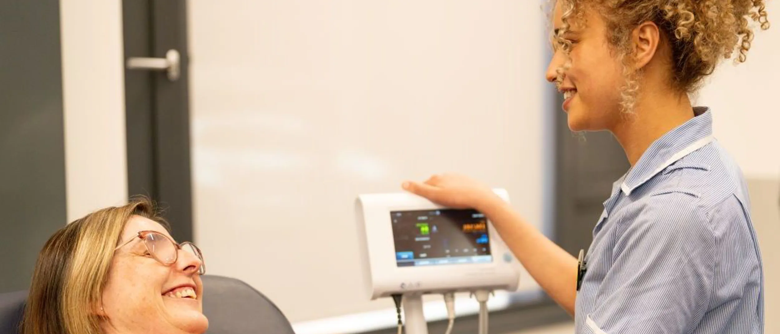 A nursing student checking vitals of a patient