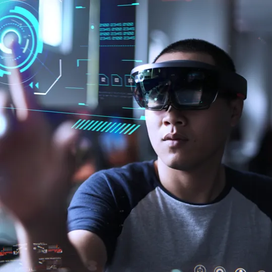 Male wear a virtual reality headset clicking on to a virtual screen.