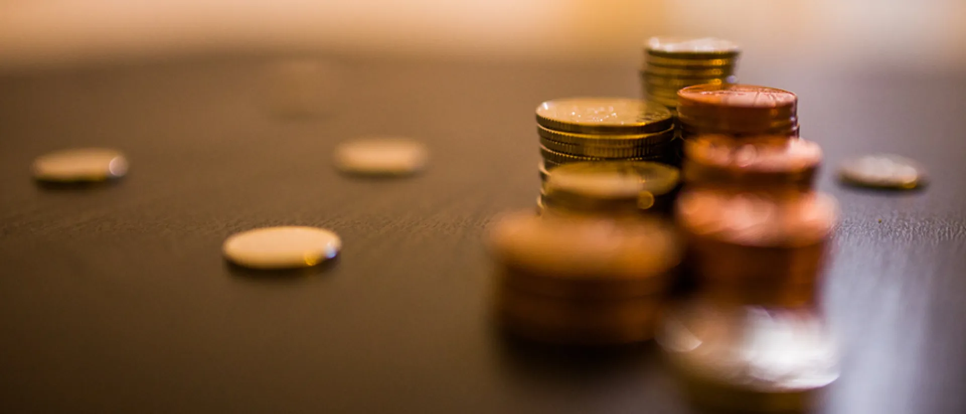 Northern Irish / Scottish funding. Scattered coins on a table