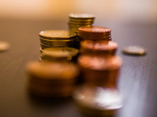 Northern Irish / Scottish funding. Scattered coins on a table