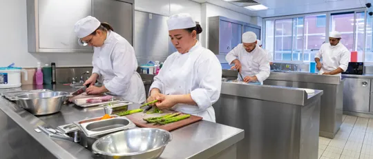 Apprentice chef cooking in kitchen